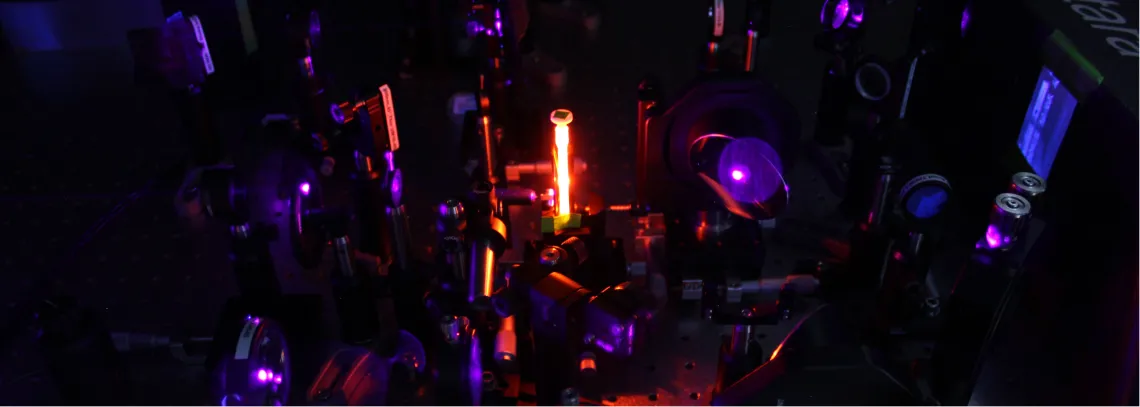 Bright orange fluorescence emission from a sample in an optical laser experiment