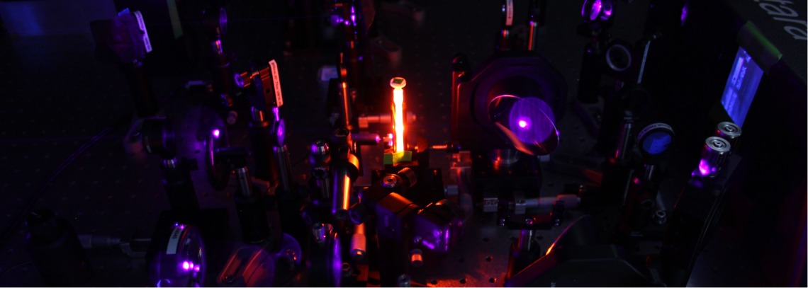 Bright orange fluorescence emission from a sample in an optical laser experiment